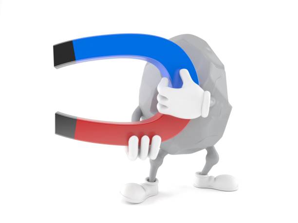 istock Rock character holding horseshoe magnet 985536168