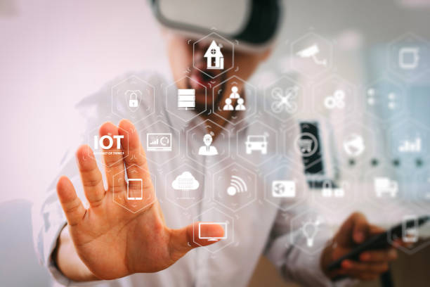 istock businessman wearing virtual reality goggles in modern office with mobile phone using with VR headset 985536600