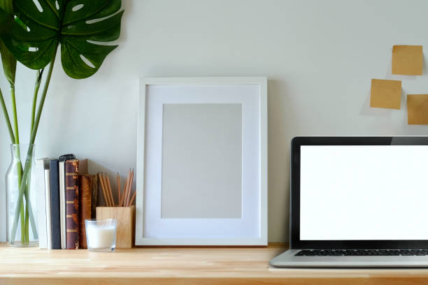 istock Minimal workspace mockup poster and laptop on studio desk. 985545048