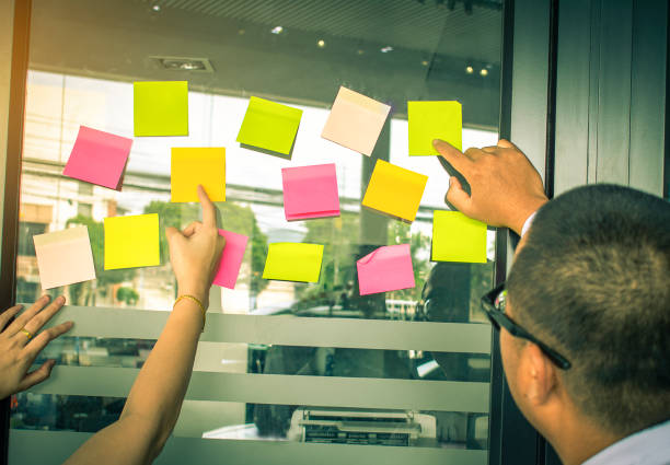 Businessman looking adhesive notes.