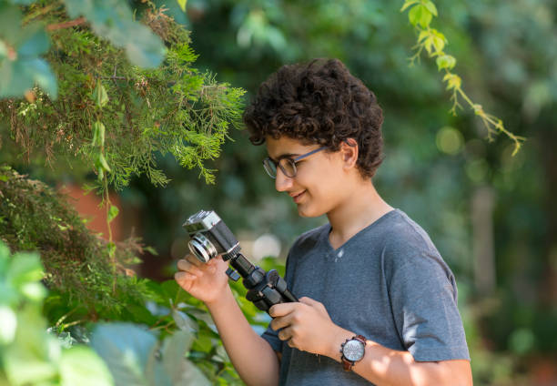 Teenage boy taking pictures outdoors