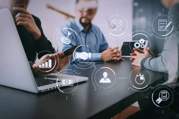 Photo of co working team meeting concept,businessman using smart phone and digital tablet and laptop computer in modern office