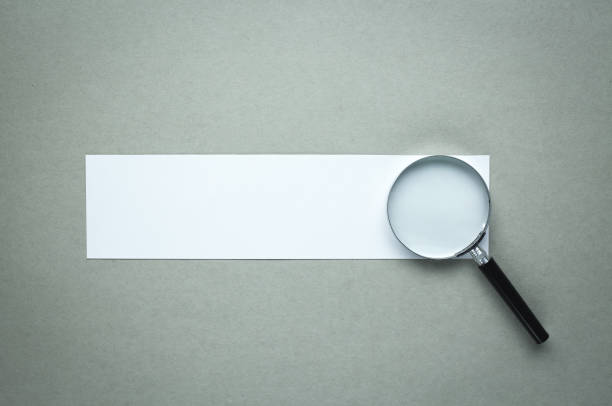 istock Magnifying glass with blank paper. Search and discover 985560124