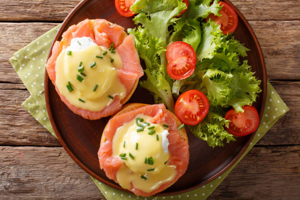 istock poached eggs with smoked salmon, hollandaise sauce and vegetables close-up. horizontal top view 985568922