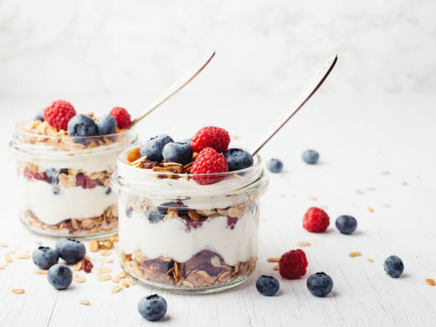 istock Granola with berries and yogurt in jars. 985577824