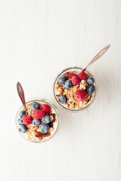 istock Granola with berries and yogurt in jars. 985577910
