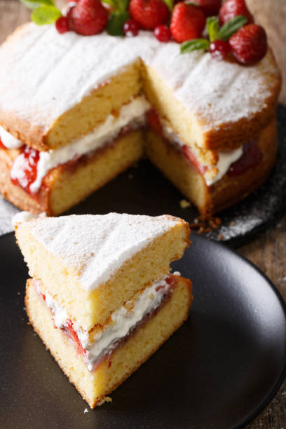 istock Sliced Victoria sandwich cake closeup on a plate. vertical 985581356