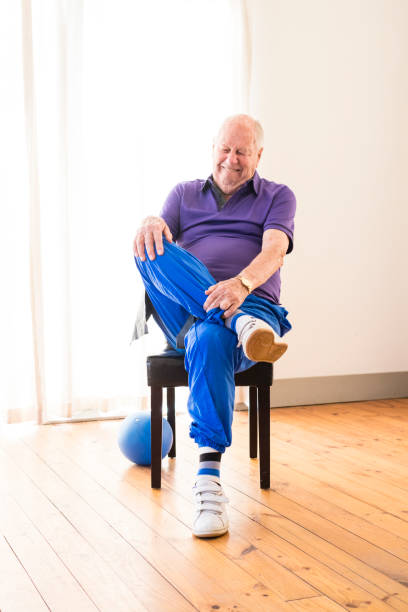 istock Senior man stretching to warm up for exercising class 985581476