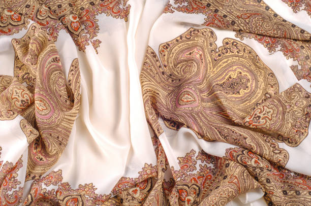 istock texture, pattern. White silk fabric with a brown pattern. A female scarf in Indian design. a drawing of any other name can smell like sweet, but will not look as gorgeous as these patterned silks. 985582522