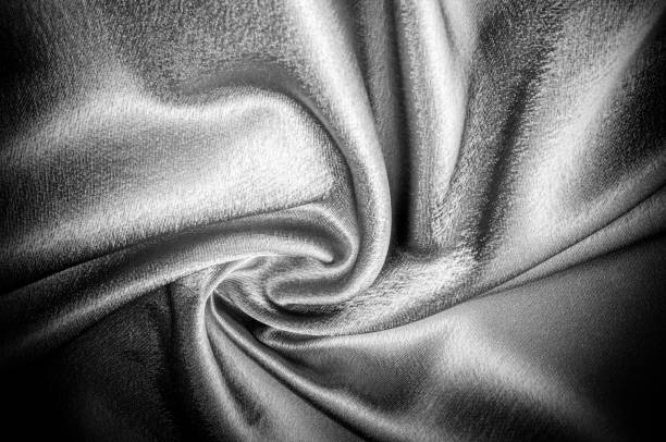 istock texture, pattern. Fabric made of silk fabric is black, This metallic black abstract jacquard is as magical as a mermaid under the water. The luminous metallic shade is mixed with the spray of color 985582766