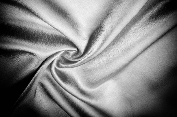 istock texture, pattern. Fabric made of silk fabric is black, This metallic black abstract jacquard is as magical as a mermaid under the water. The luminous metallic shade is mixed with the spray of color 985582794