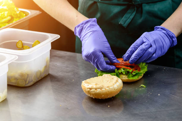 istock Unidentified chef preparing veggie burger with yummy vegetable p 985583156