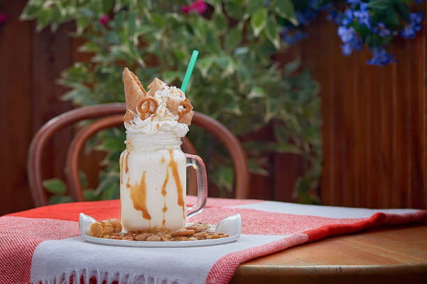 Milk shake in the jar. Delicious vanilla dessert in a cafe