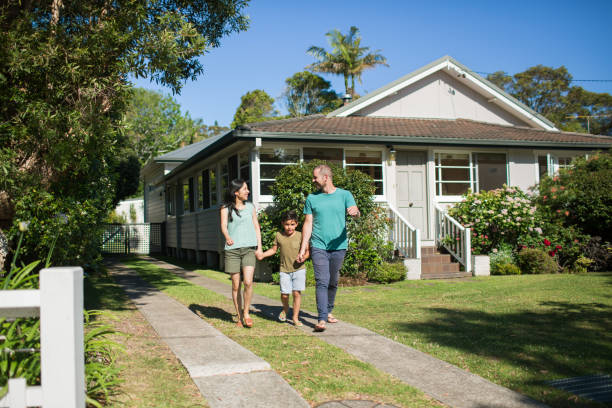istock Boy holding hands of parents while walking in lawn 985596034