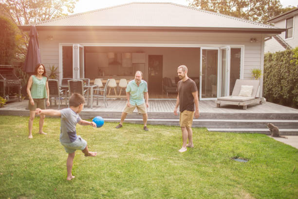 istock Multi-generation family playing soccer in lawn 985596078