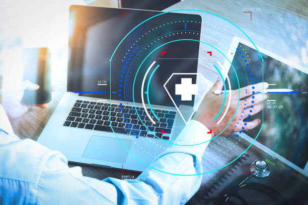 istock doctor hand working with modern digital tablet and laptop computer with smart phone as medical network concept 985596232