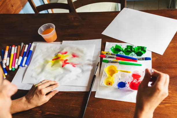 istock Woman coloring with watercolor 985597244