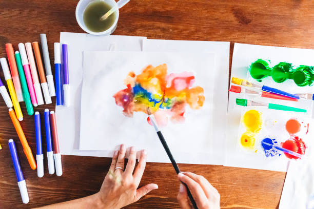 istock Woman coloring with watercolor 985597278