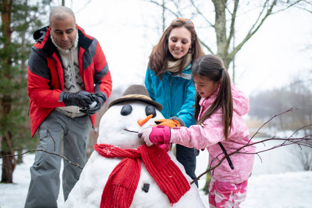 istock Building a Snowman with her Family 985601618