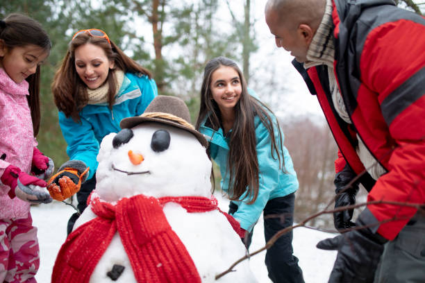 istock Building a Snowman with her Family 985601856