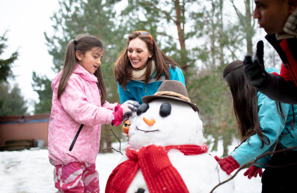 istock Building a Snowman with her Family 985601858