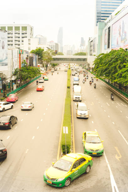 Bangkok, Thailand - April 30 2018:  A view of Payathani Road, looking towards the famous Mahanakhon Tower in the distance.  This is central Bangkok, however quiet in the early morning traffic.