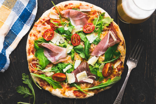 istock Hot italian pizza on wooden table 985615510
