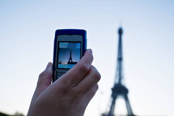 istock Hand Holding An Image Of Iconic Eiffel Tower (Paris - France) On Mobile Device Screen 985617738
