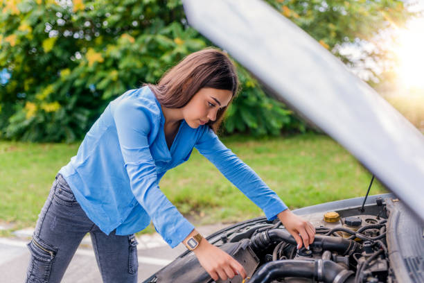 istock Woman standing by her broken car 985624626