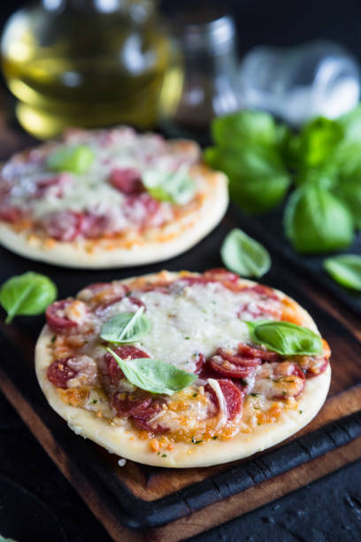 istock Mini pizzas with pepperoni and cheese 985628956