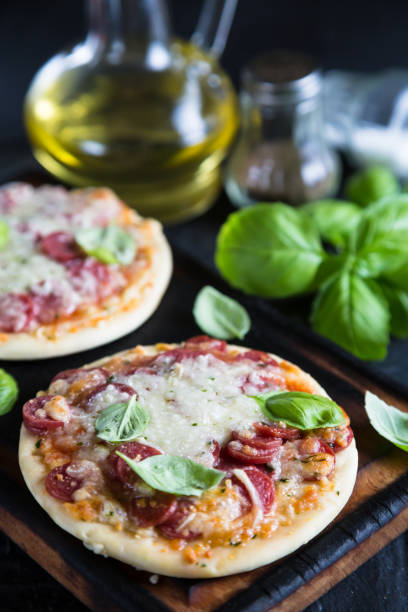 istock Mini pizzas with pepperoni and cheese 985629222