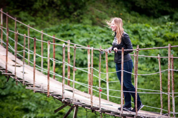 istock Girl on the wooden bridge 985635292