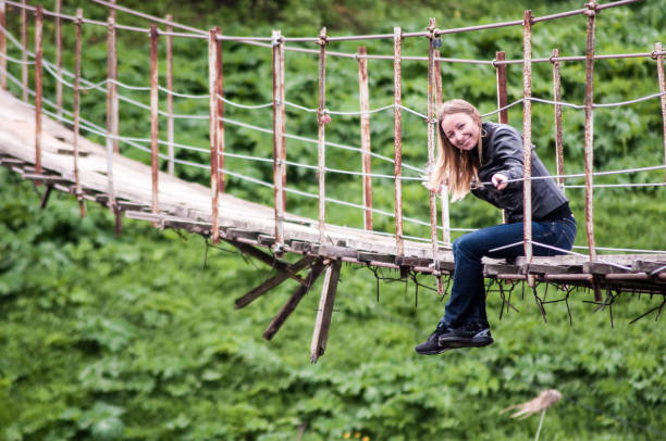 istock Girl on the wooden bridge 985635302
