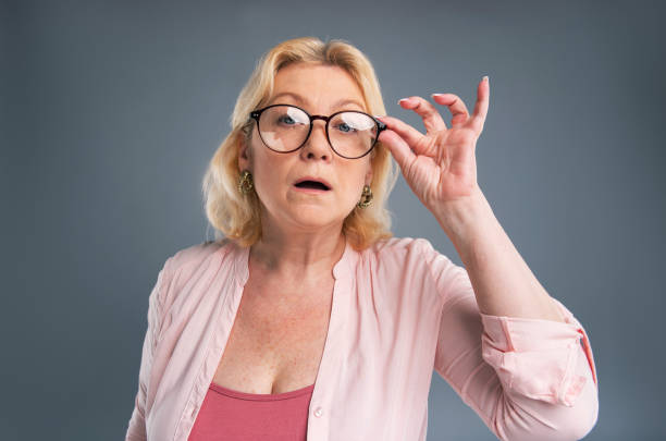 istock Charming senior woman adjusting her eyeglasses 985638520