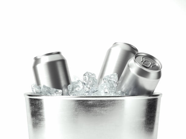 Metal cans of beer with ice cubes in mini refrigerator, close up. Lots of aluminum cans in the ice in the open fridge. Drops of water on a cold can of drink.