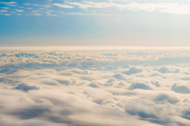 Panorama sky from altitude in the cumulus and layered stratus clouds sunset sunrise. Panorama sky from altitude in the cumulus and layered stratus clouds sunset sunrise sun above clouds stock pictures, royalty-free photos & images
