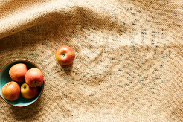istock a bowl of organic apples on raw fabric 985655328