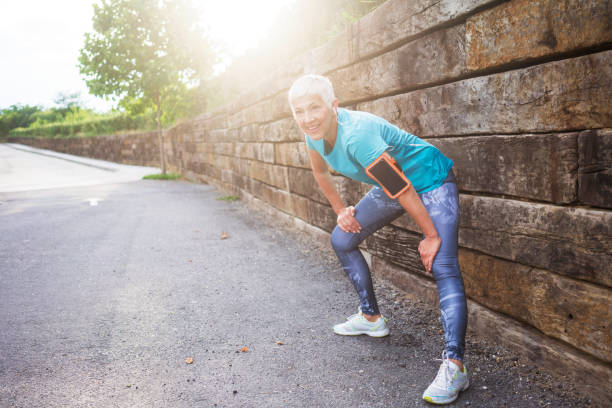 istock Mature woman jogging 985655800