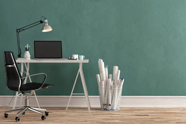 Workdesk with decoration on hardwood floor in front of empty teal wall with copy space. 3D rendered image.