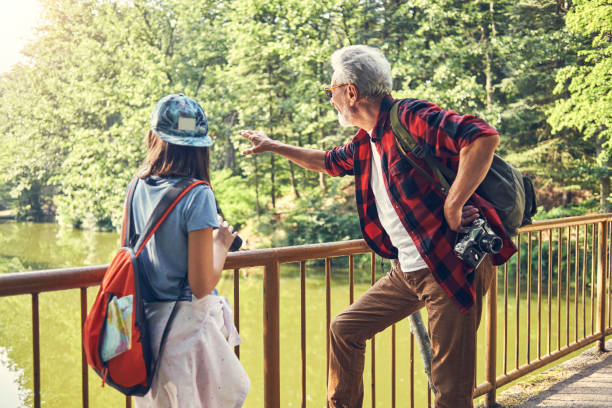 istock grandfather and his granddaughter exploring the forest 985656832