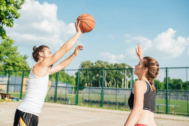 istock Young couple playing basketball 985661838