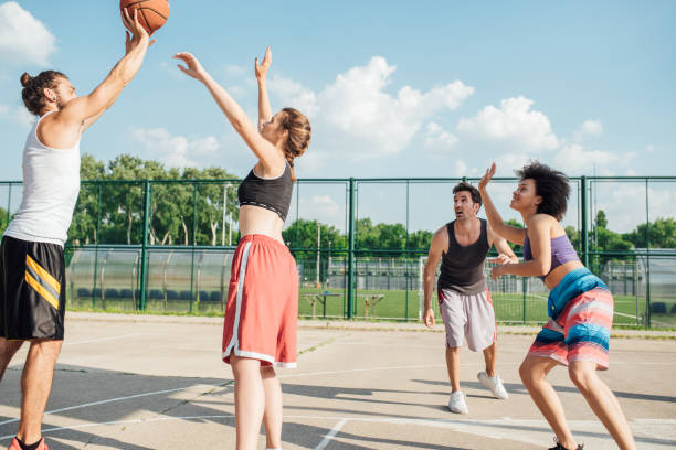 istock Young man playing basketball with friends 985661920