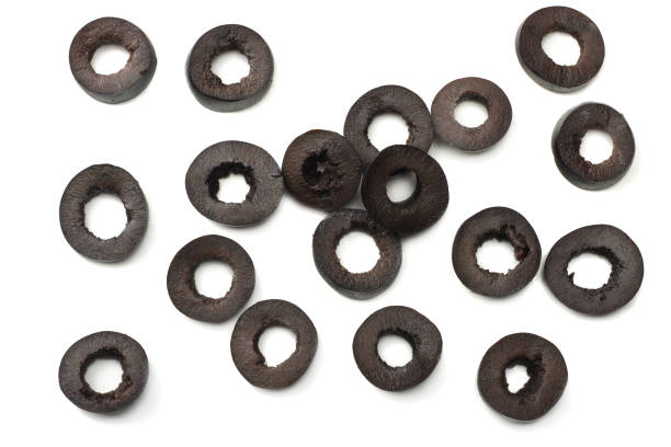 istock Marinated slices black olives isolated on white background. top view 985663308