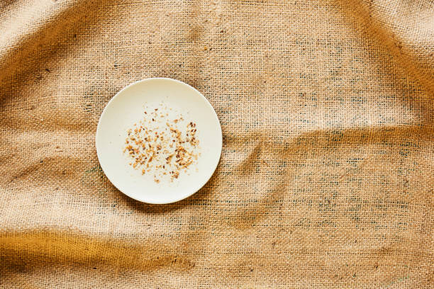 empty plate with bread crumbs on raw fabric