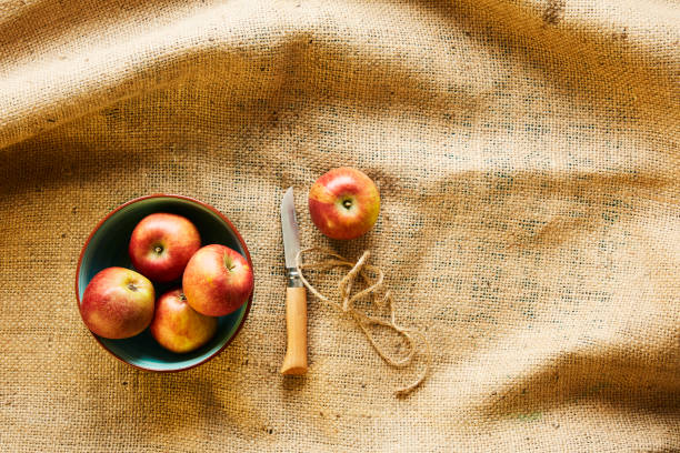 istock red organic apples in bowl with knife on fabric 985664930