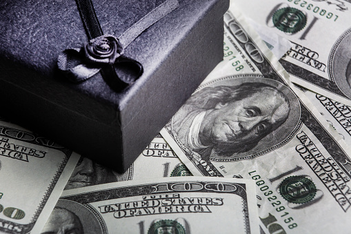 Black gift box and dollars