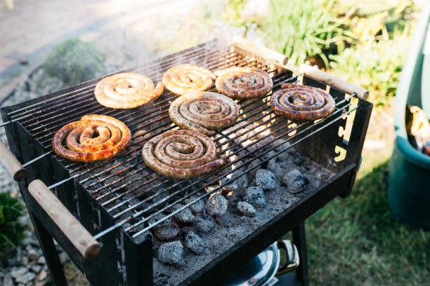 istock fresh sausages wrapped in a snail on the grill 985665510