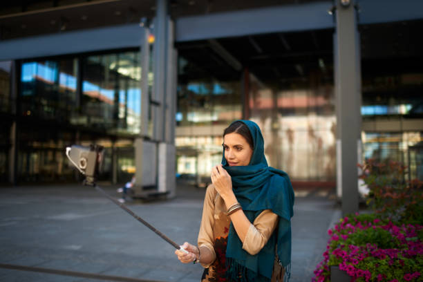 istock Muslim woman with selfie stick 985671510