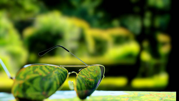 istock Tropical park behind the sunglasses on the map 985677792