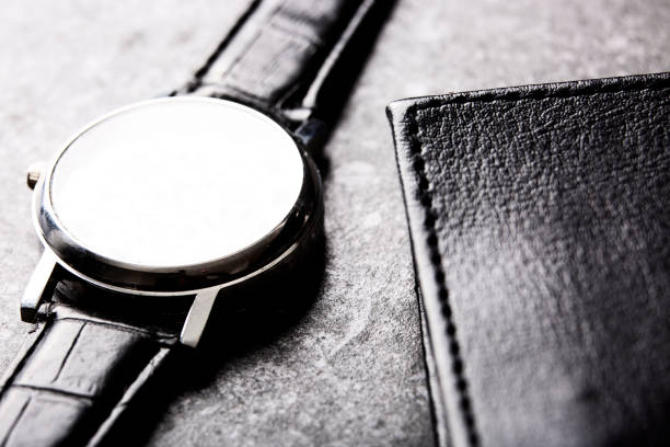 Leather wallet and wrist watch close-up